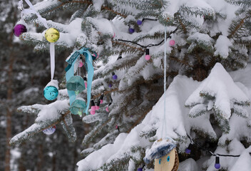 Toys on the Christmas tree outside before Christmas.