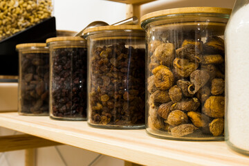 Self service bulk organic food. Eco-friendly zero waste shop. Small local business. Dehydrated apricot, blueberry, raisins sultans and figs - obrazy, fototapety, plakaty