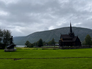Fototapeta na wymiar Scene of a rainy and foggy day at the wooden church of Lom, Norway