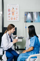 Fototapeta premium Woman Doctor and patient discussing something while sitting at the table . Medicine and health care concept.