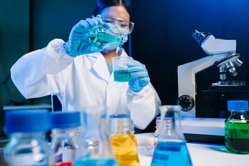 Modern medical research laboratory. female scientist working with micro pipettes analyzing...
