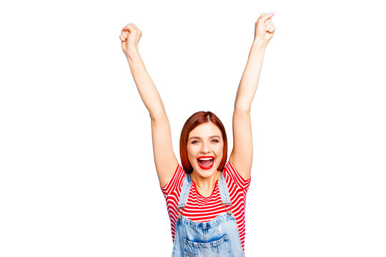 Portrait of nice vivid girlish red straight-haired glad happy smiling young girl with opened mouth, raising hands up, isolated over blue background