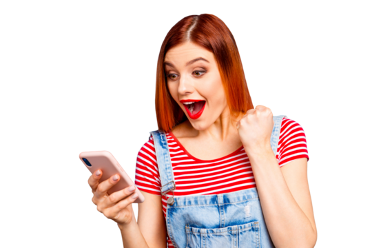 Nice vivid girlish red straight-haired happy smiling girl reading sms notification about winning, isolated over blue background, copy space