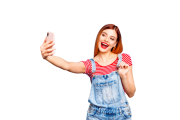 Portrait of nice vivid red straight-haired excited happy smiling young girl with opened mouth taking self picture, isolated over blue background