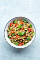 Quinoa tabbouleh salad in a bowl, a healthy dinner with tomatoes and mint. top shot - 761332917
