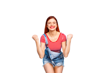 Portrait of happy red-haired girl in red striped T-shirt closed her eyes with a celebrating victory and clenching her fists isolated on shine vivid blue background