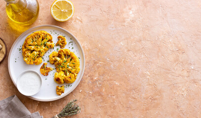 Cauliflower steaks with white sauce. Healthy eating. Vegetarian food.