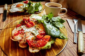 Breakfast at a cafe. Toast with egg, tomato, and spinach, with a cup of coffee, morning atmosphere - 761334753