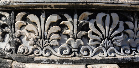 Column base, Apollo temple at Didima, close-up, carved acanthus leaves, marble relief, shadow play,...