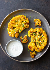 Cauliflower steaks with white sauce. Healthy eating. Vegetarian food.