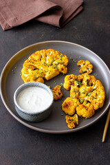 Cauliflower steaks with white sauce. Healthy eating. Vegetarian food.
