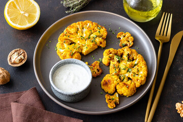 Cauliflower steaks with white sauce. Healthy eating. Vegetarian food.
