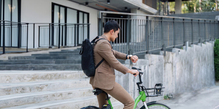 Young businessman ride bicycle to work. Reduce global warming Help save energy. Eco friendly concept