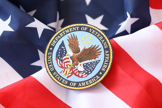KYIV, UKRAINE - MARCH 9, 2024 US Department of Veteran Affairs seal on United States of America flag close up