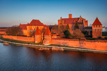 Malbork castle over the Nogat river at sunset, Poland - 761345585