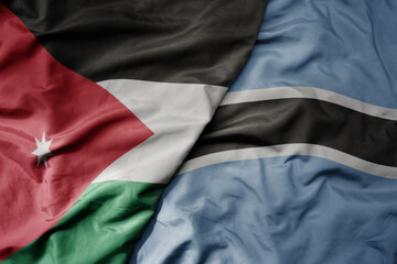 big waving national colorful flag of botswana and national flag of jordan.