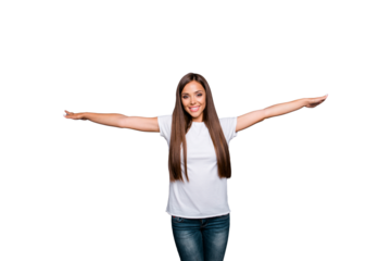 Attractive and pretty brunett woman opens her hands to the side like a wide of plane isolated on gray background