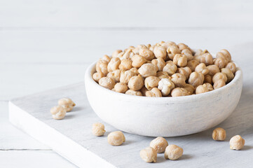 Uncooked dried chickpeas in bowl or spoon on table. Heap of legume chickpea background