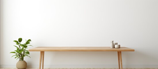 A hardwood rectangular table with a plant on top, placed in front of a white wall. The fixture adds a touch of nature to the rooms decor - obrazy, fototapety, plakaty