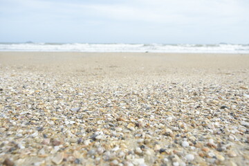 Fototapeta na wymiar Sand beach with light waves