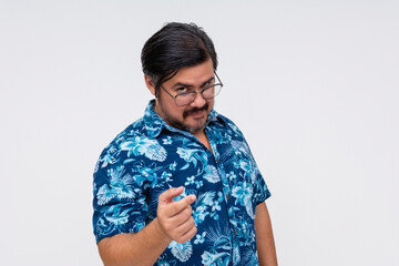 Assertive or belligerent middle-aged man in a blue Hawaiian shirt pointing finger with a stern...