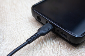 Smartphone charging. Charge your smartphone battery with a cable.