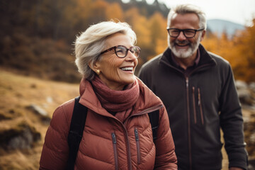 Fototapeta premium Couple is smiling and walking together in woods