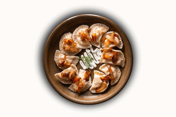 Dumplings with meat, onions and meat on a cast iron skillet. Selective focus. Overhead view of...