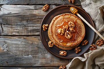  buckwheat pancake topped with honey drizzle and walnuts, positioned at the center of a rustic wooden table