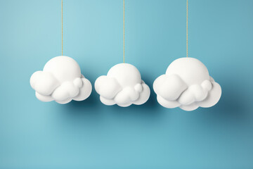 Three white clouds hanging from blue background