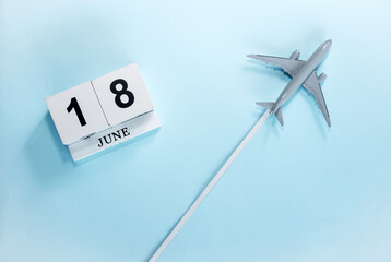 June calendar with number  18. Top view of a calendar with a flying passenger plane. Scheduler....