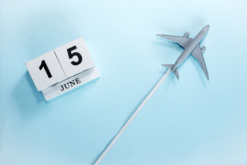 June calendar with number  15. Top view of a calendar with a flying passenger plane. Scheduler....