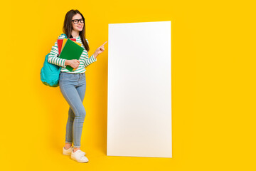 Full size photo of intelligent college student female promote placard banner isolated on yellow color background