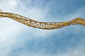 Empty ride roller coaster in amusement park on blue sky background.