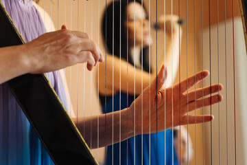 Hungarian harpist playing an electronic harp with a Latin singer