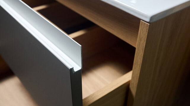 Sliding lockers with aluminum extruded G profile handles for bathroom kitchen cabinets. Solutions for placing things in bathroom horizontal sliding pull out drawer shelves storage of cupboard.