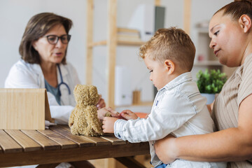 caucasian curvy mother with her son visit pediatrician in hospital.consultation with female doctor Child care, healthcare, medicine concept.