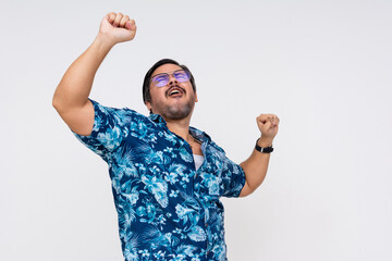 Exuberant and rowdy middle-aged male in a vibrant Hawaiian shirt dancing with joy. Perfect imagery...