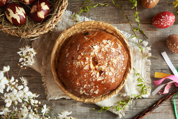 Traditional Czech sweet round Easter cake called mazanec, with eggs dyed with onion peels and...