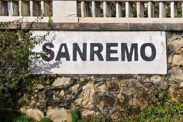 Close-up of the city sign on the Empress Walk promenade of the coastal city, famous for hosting the most ancient festival of the Italian song, Sanremo, Imperia, Liguria, Italy