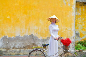Vietnamese woman in “Ao Dai” traditional dress of vietnam