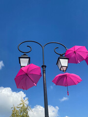 pink umbrellas on blue sky