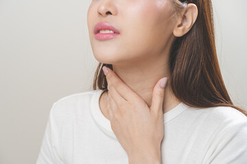 Sickness in inflaming asian young woman, girl use hand check self touch at sore throat, pain...