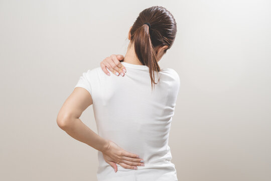 Pain body muscles stiff problem, asian young woman, girl painful with back, neck ache from work hand holding massaging rubbing shoulder hurt, sore on white background. Health care and medicine concept