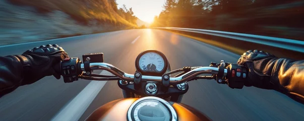 Schilderijen op glas Motorbike rider in sunset light riding with high speed against motion blured background © Daniela