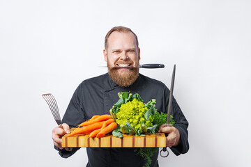 A positive chef ready for vegetarian cooking. Healthy eating concept.