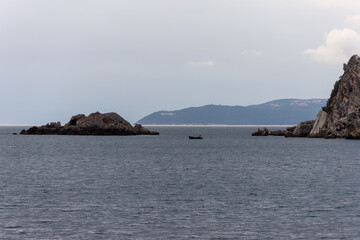 Fototapeta na wymiar island and fisherman boat in the sea