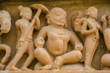Fototapeta na wymiar Beautiful stone carved sculptures on the outer wall of the temple, Khajuraho, Madhya Pradesh, India, Asia.