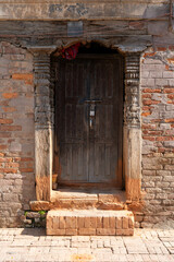 Closed Wooden Door in Brick Wall