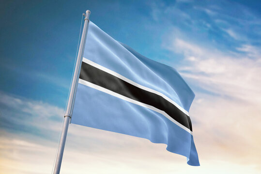 Waving flag of Botswana in blue sky. Botswana flag for independence day. The symbol of the state on wavy fabric. - Powered by Adobe
